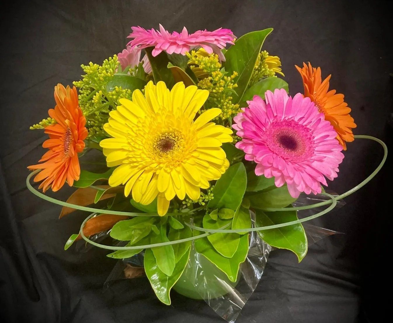 A Vase Filled With Yellow and Pink Daisies and Greenery — Wingham Nursery and Florist PTY Ltd In Wingham, NSW