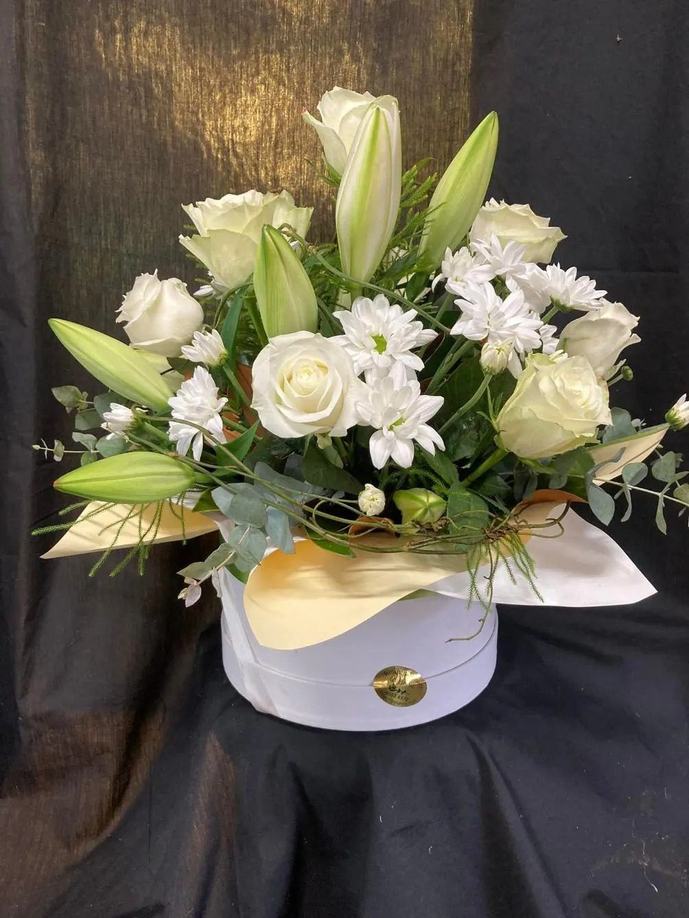 A White Box Filled With White Flowers is Sitting on a Table — Wingham Nursery and Florist PTY Ltd In Wingham, NSW