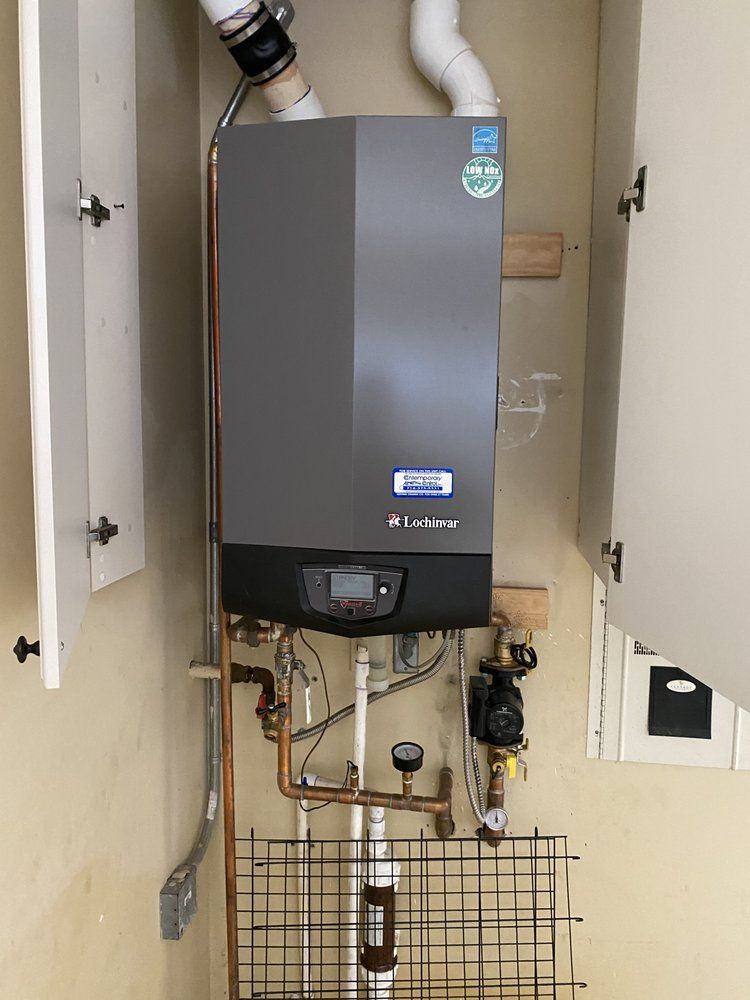 A boiler is hanging from the wall in a room.