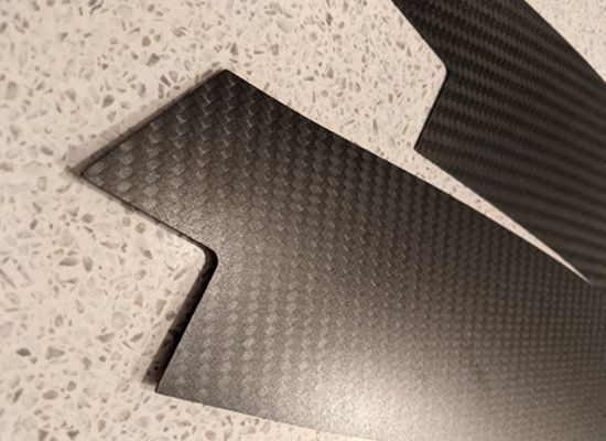 A piece of carbon fiber is sitting on a counter.
