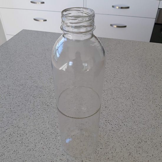 A clear plastic bottle is sitting on a counter.