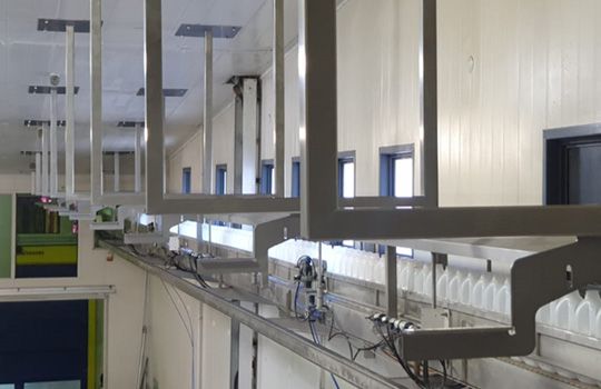 A metal railing is hanging from the ceiling of a building.