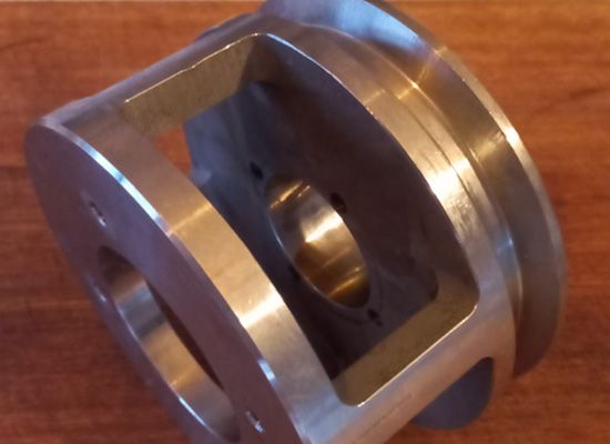 A metal object is sitting on a wooden table