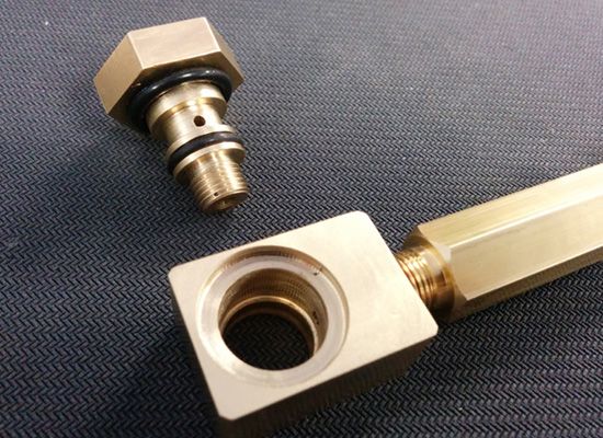 A close up of a brass piece with a hole in it