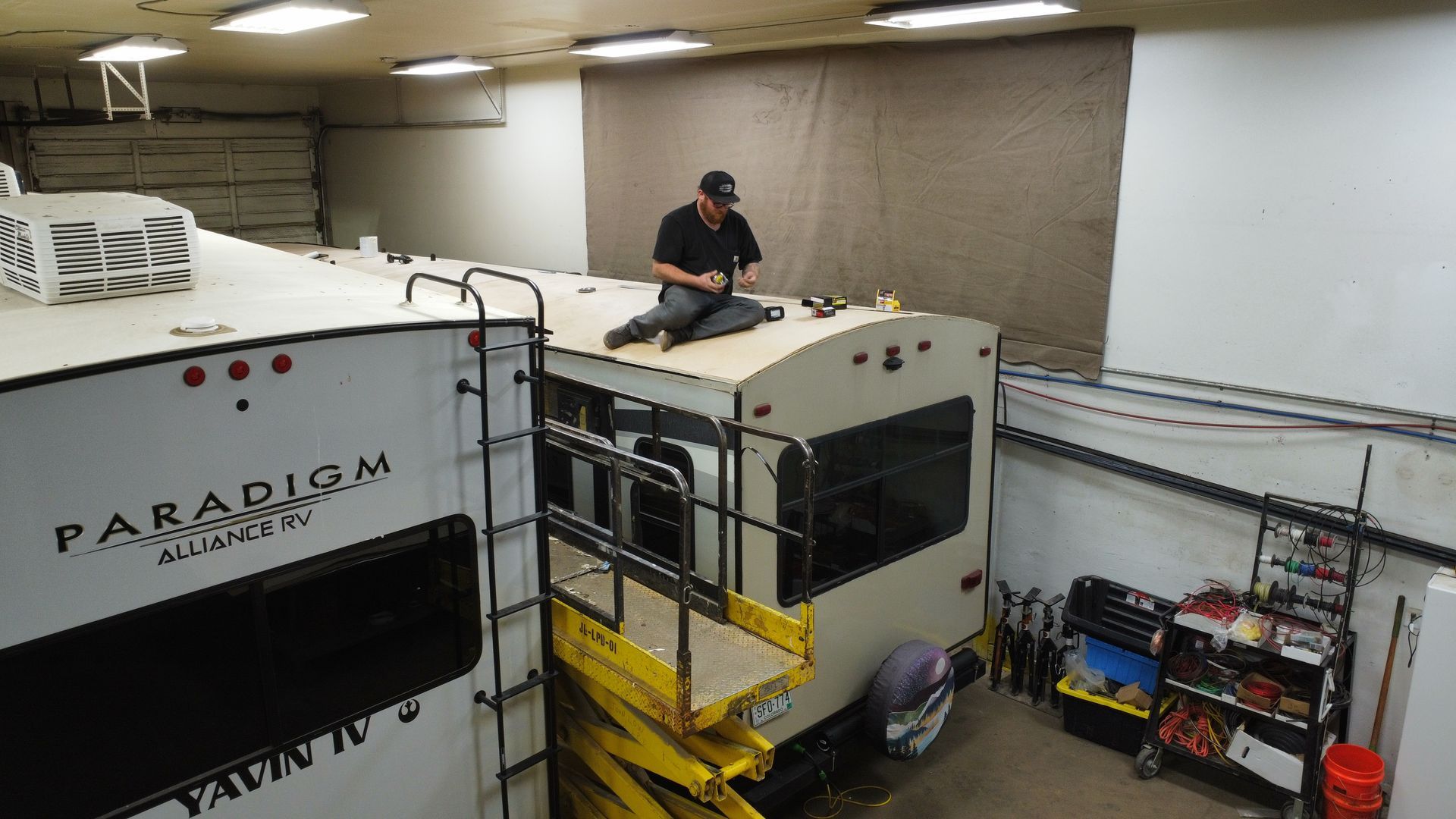 RV roof repair technician working on motorhome roof