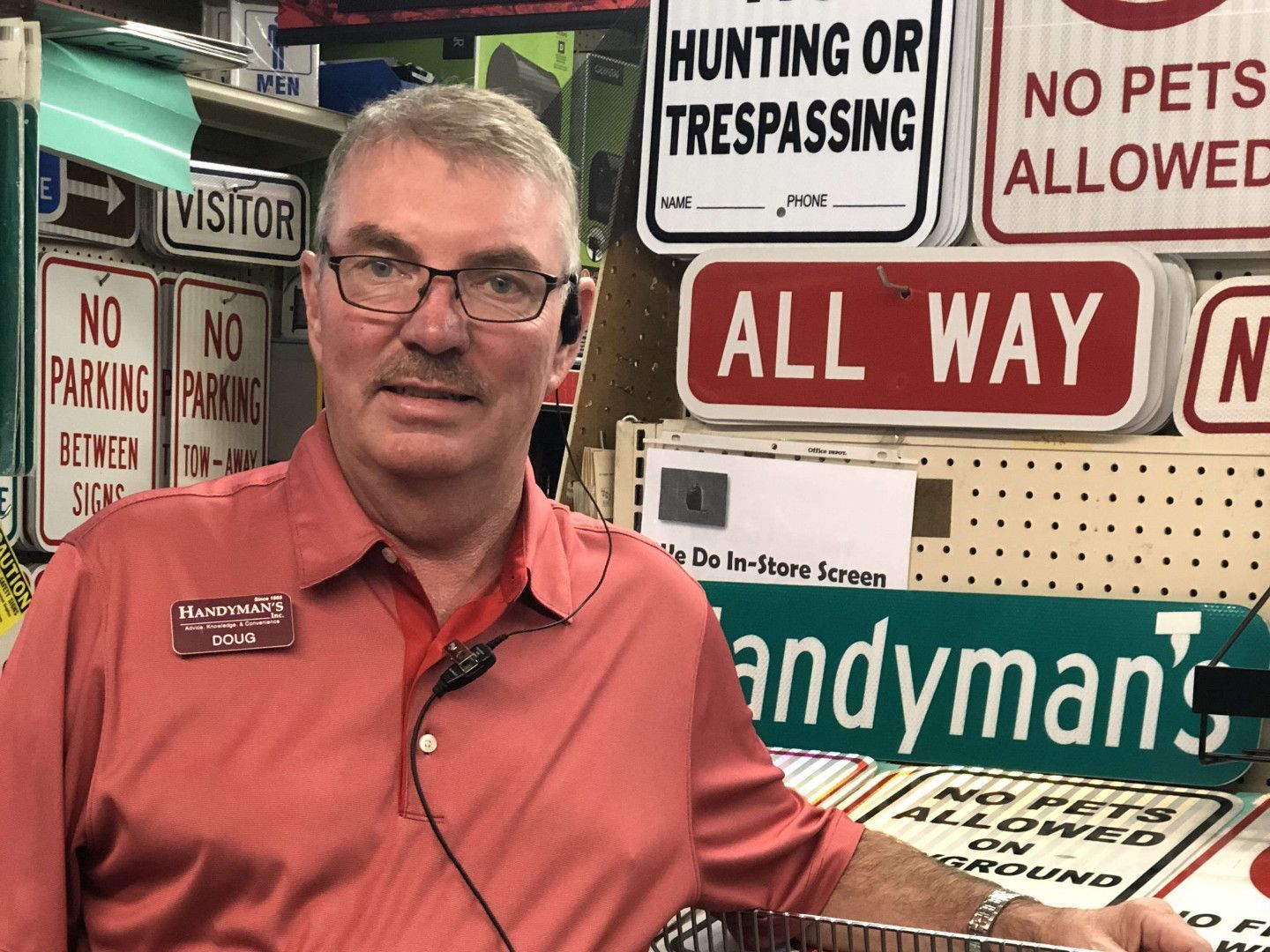 A man standing in front of a sign that says all way