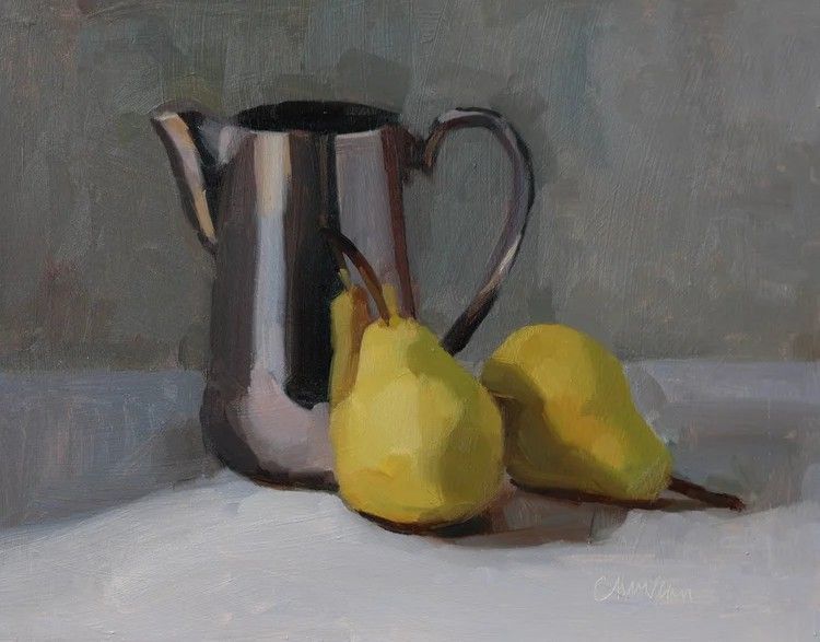 Still life of a metal pitcher with two yellow pears on a white tablecloth against a gray background