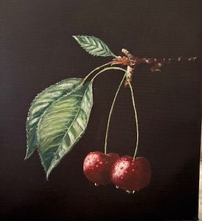 Two red cherries with green leaves on a dark background