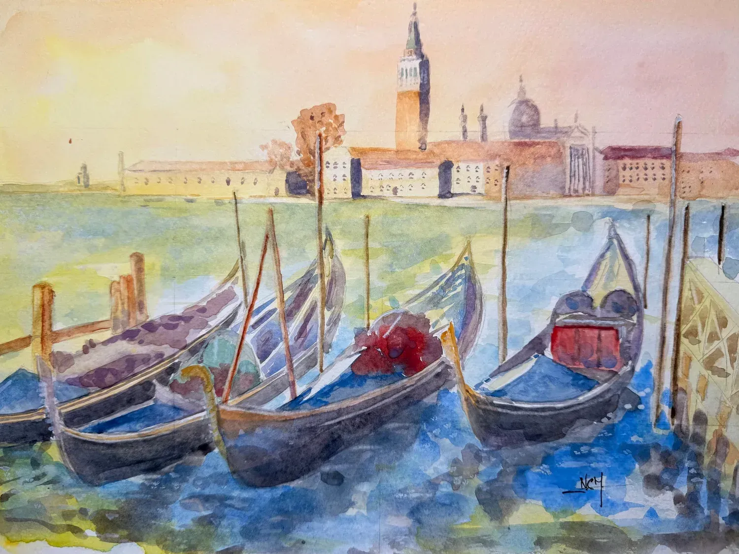 Watercolor of gondolas on a canal with a distant church tower at sunset.