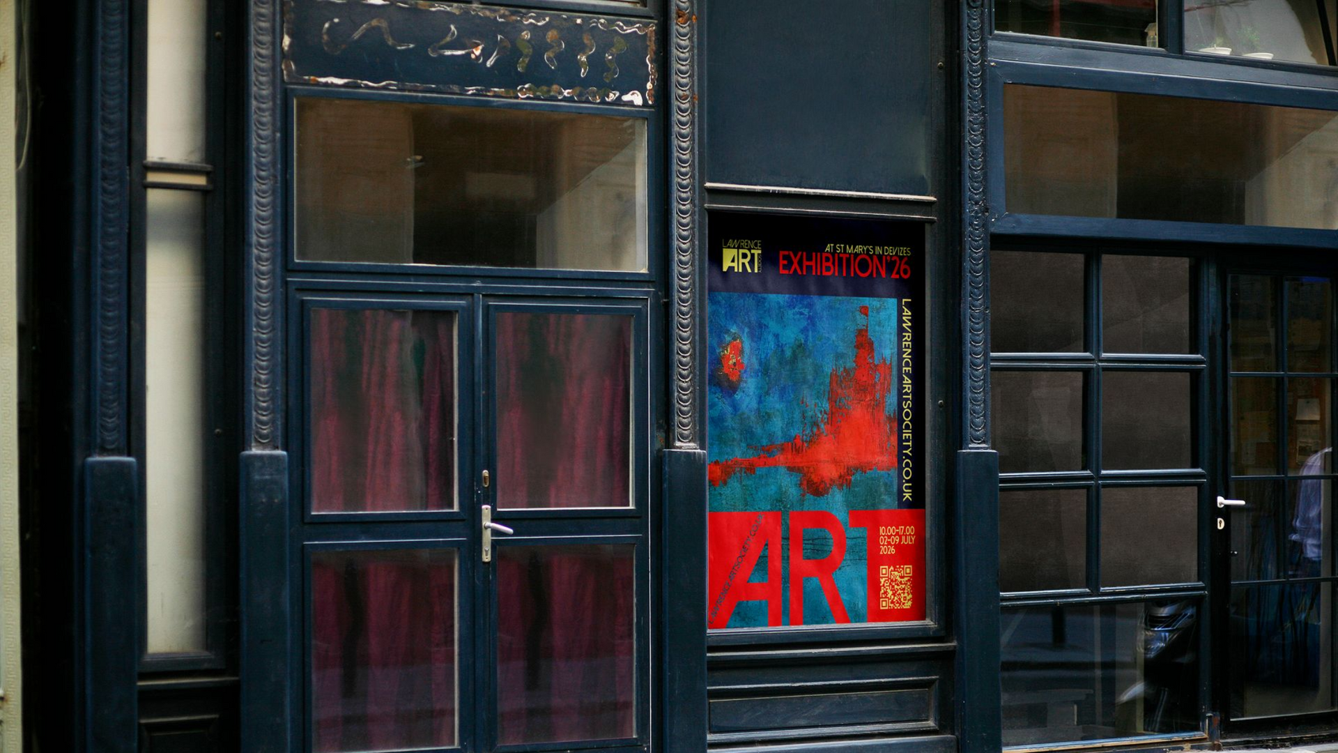Old storefront with dark windows and a red-blue poster in the center pane