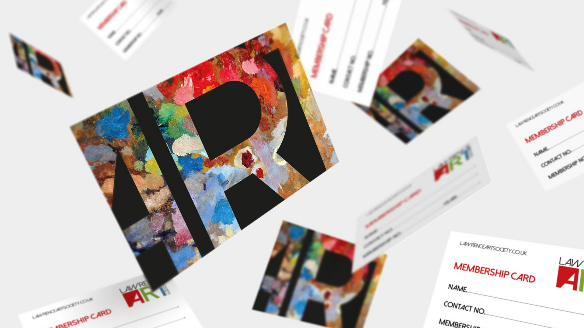 Assorted colorful business cards scattered on a white background, featuring a large tilted card with bold letters.