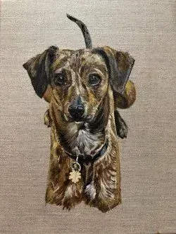 Brown-and-black dog portrait on a beige background, with one paw raised and a collar tag.