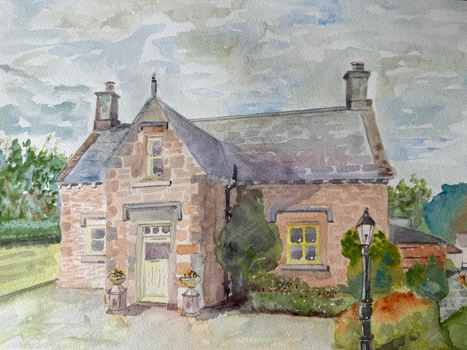 Watercolor of a stone cottage with two chimneys, a front door, and a garden lamp in a rural setting