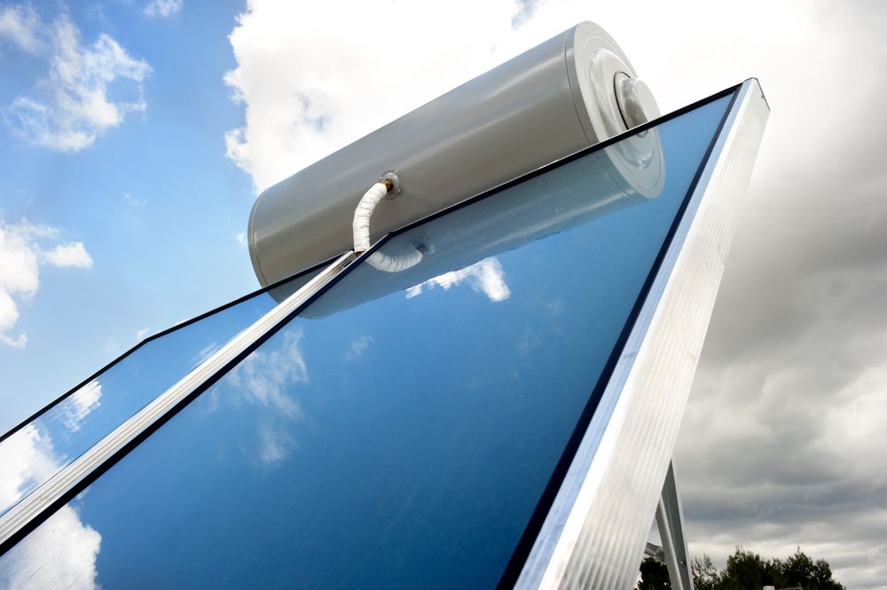A Solar Water Heater With a Large Cylindrical Storage Tank Above — Dunnerite Plumbing in Mount Peter, QLD