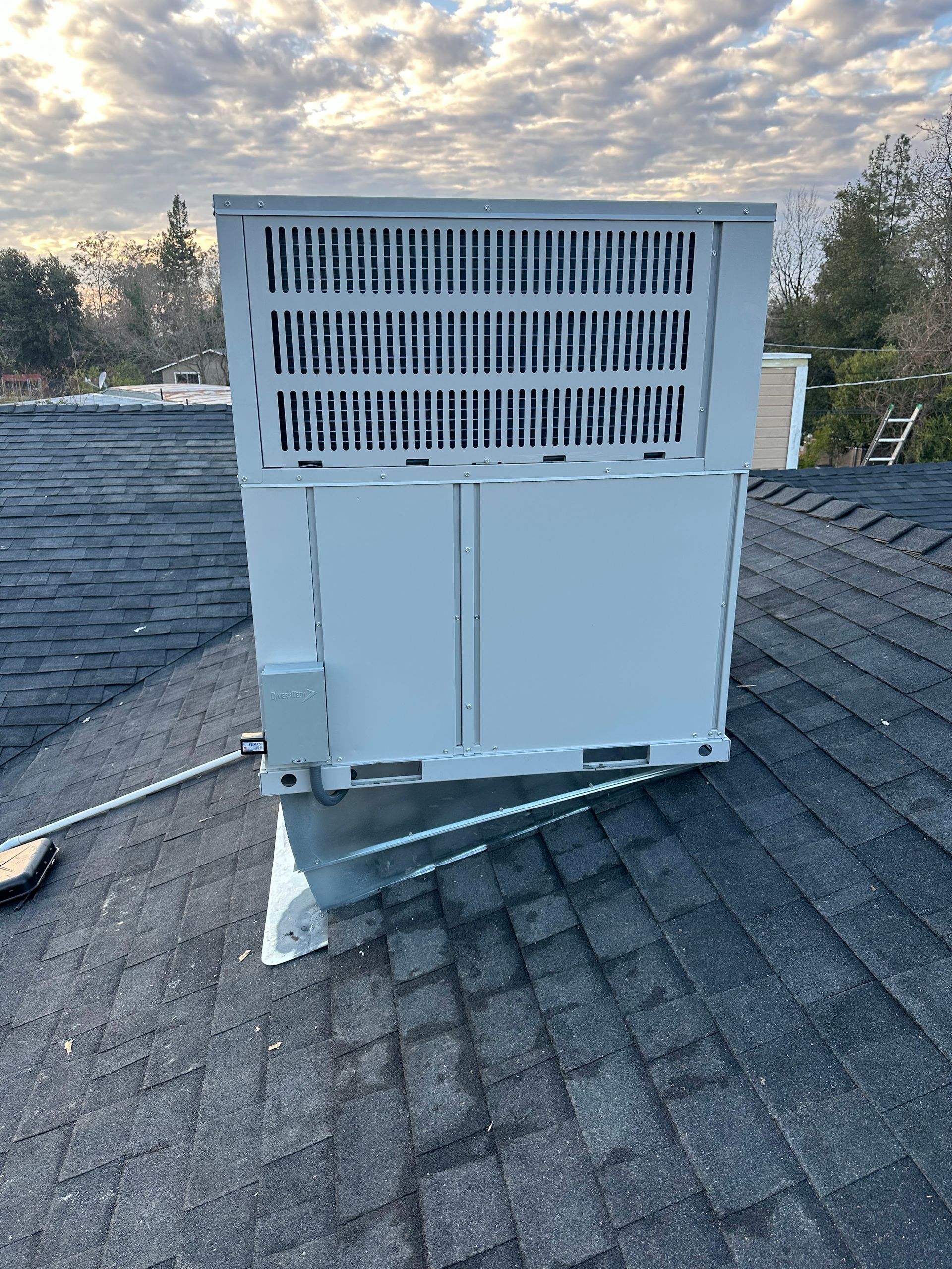 A white box is sitting on top of a roof.