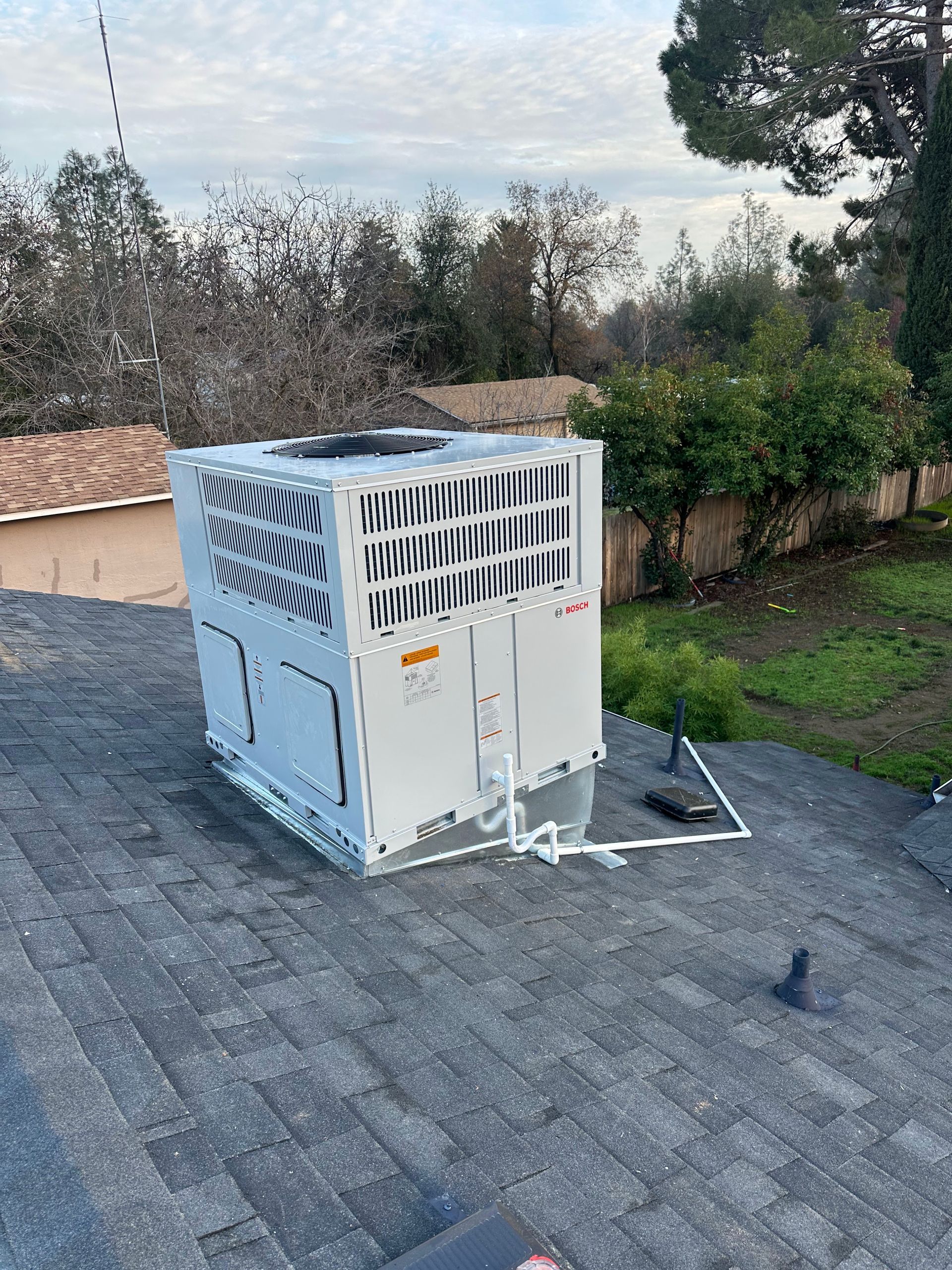 A white box is sitting on top of a roof.