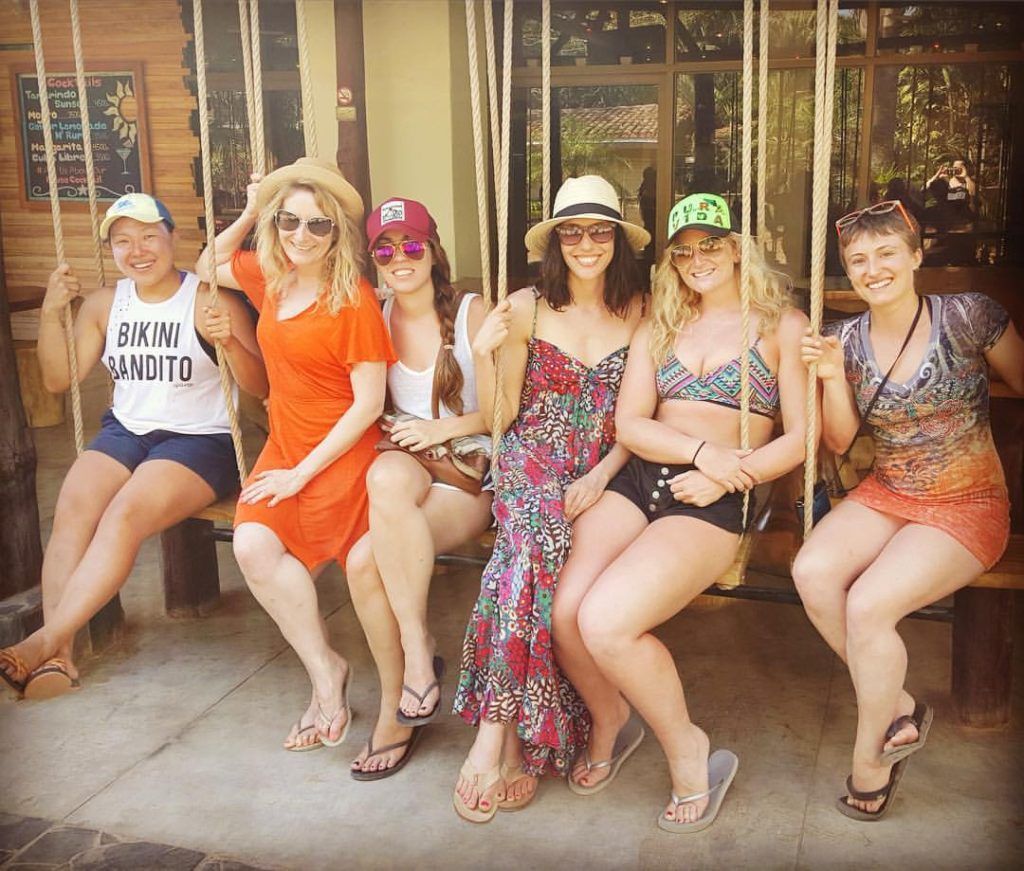 Witch's Rock Surf Camp crew of female solo travelers on a swing.