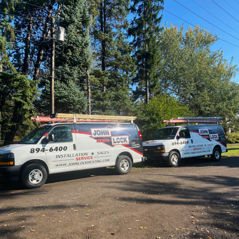 Two white service vans with red and black