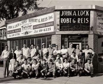 A black-and-white photo of a large group posing outside the 