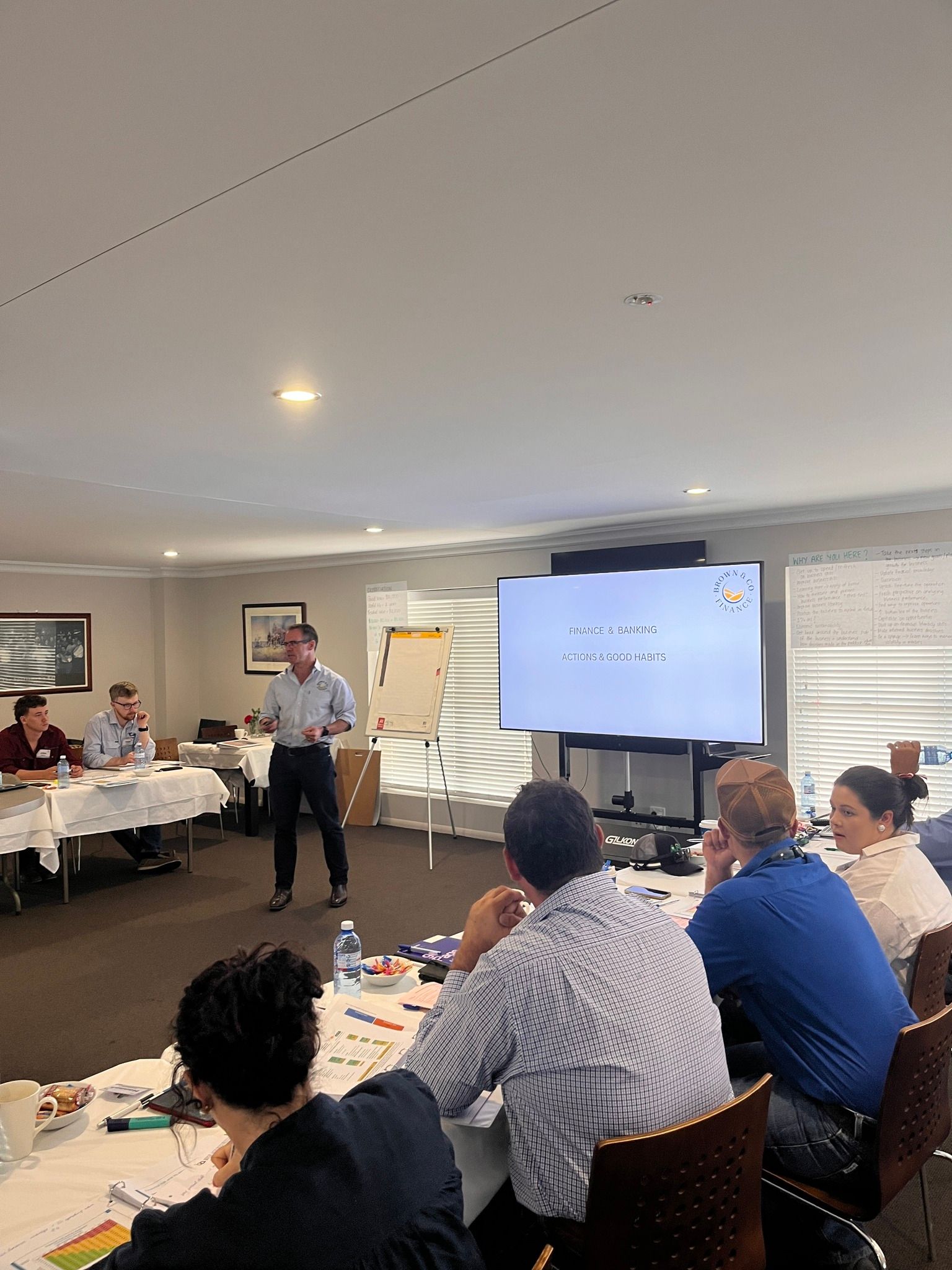Man Standing In Front Of People At Seminar — Brown & Co Finance in Miles, QLD