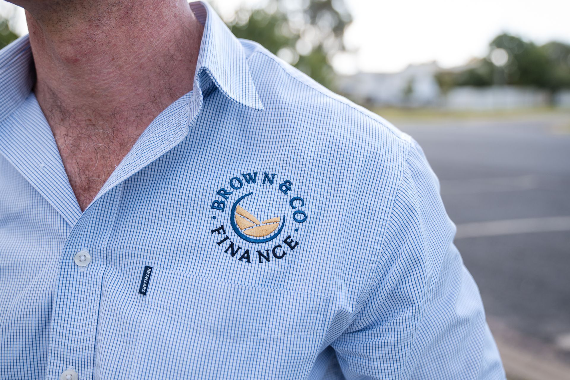 A Man Is Sitting At A Table Talking To Another Man — Brown & Co Finance in Toowoomba, QLD
