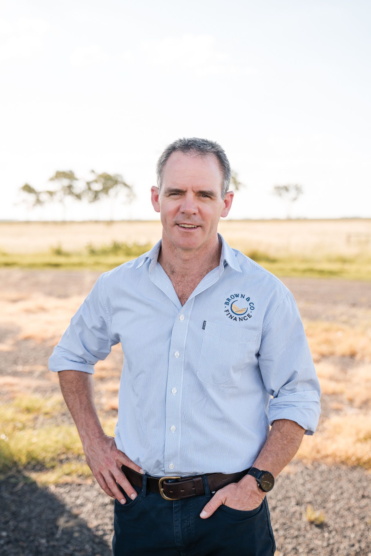 Three People Are Standing Next To Each Other In A Room — Brown & Co Finance in Gatton, QLD