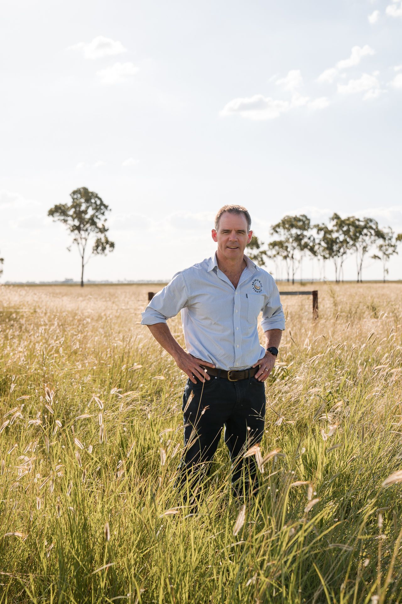 Owner in a field of golden wheat— Brown & Co Finance in Dalby, QLD