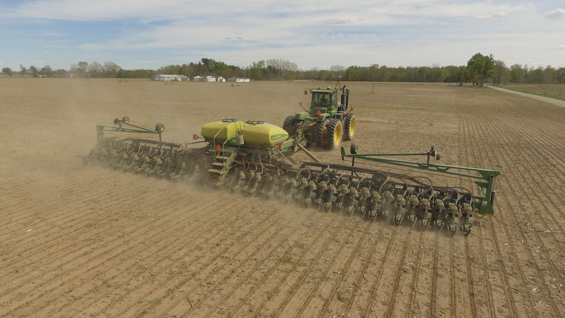 An Aerial View Of A Combine Harvester Working In A Field — Brown & Co Finance in Miles, QLD
