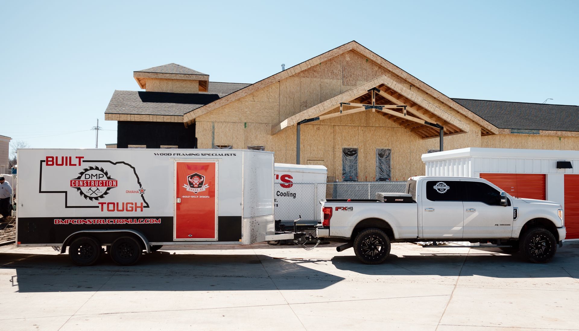 White truck towing a trailer with 