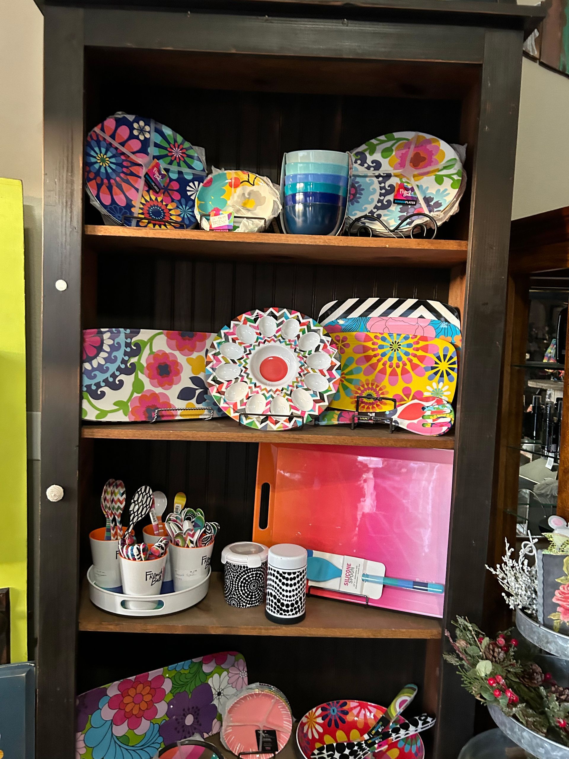 A shelf filled with colorful plates and cups