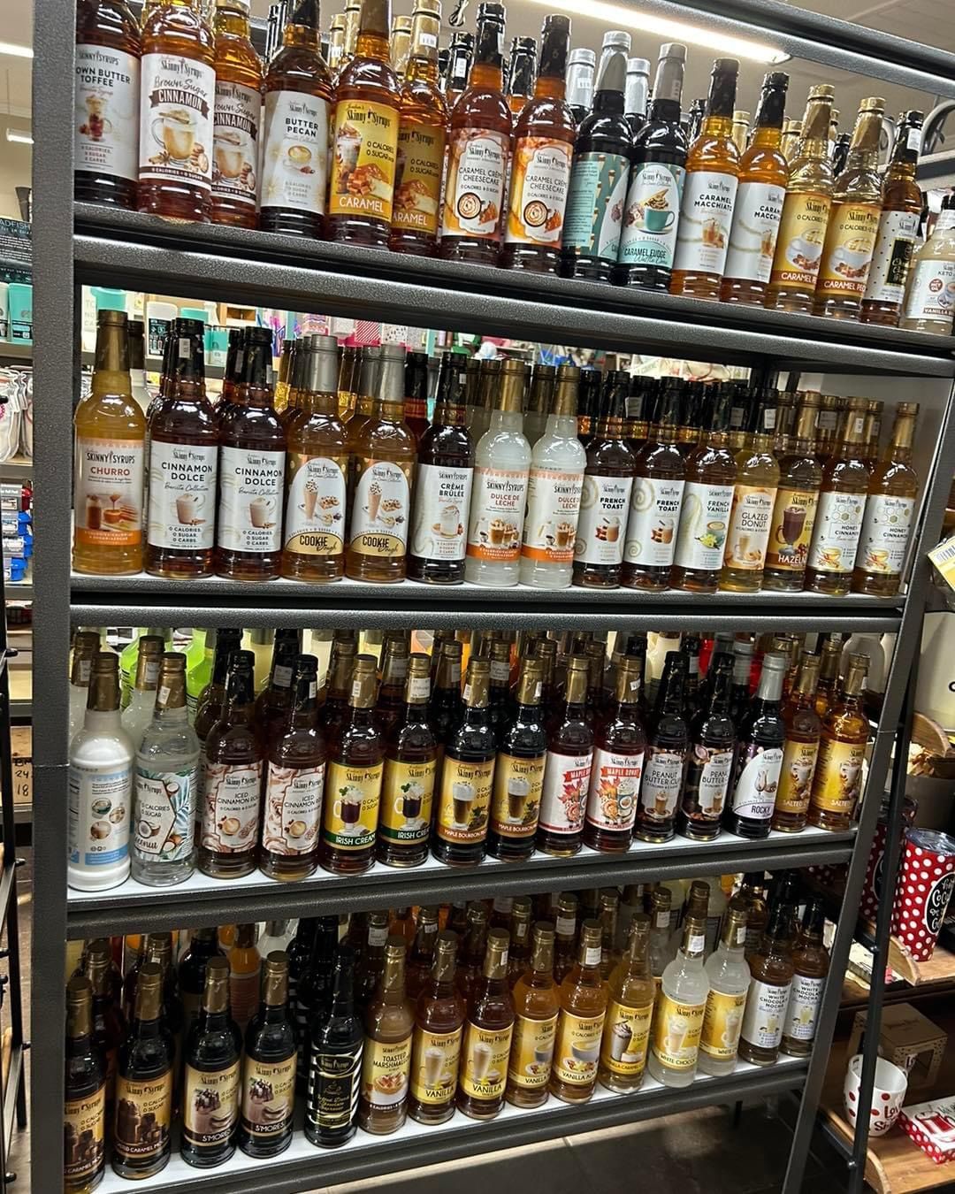 A shelf filled with lots of bottles of liquor in a store.