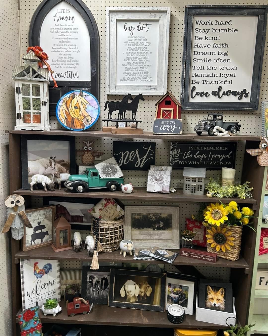 A shelf filled with lots of decorations and signs.