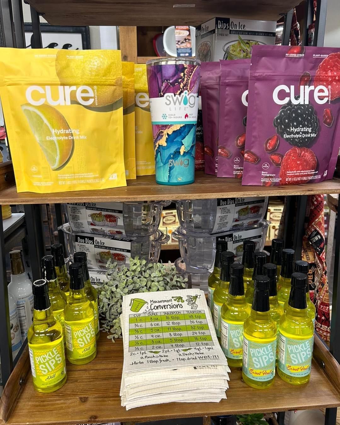 A shelf filled with bottles and bags of cure.