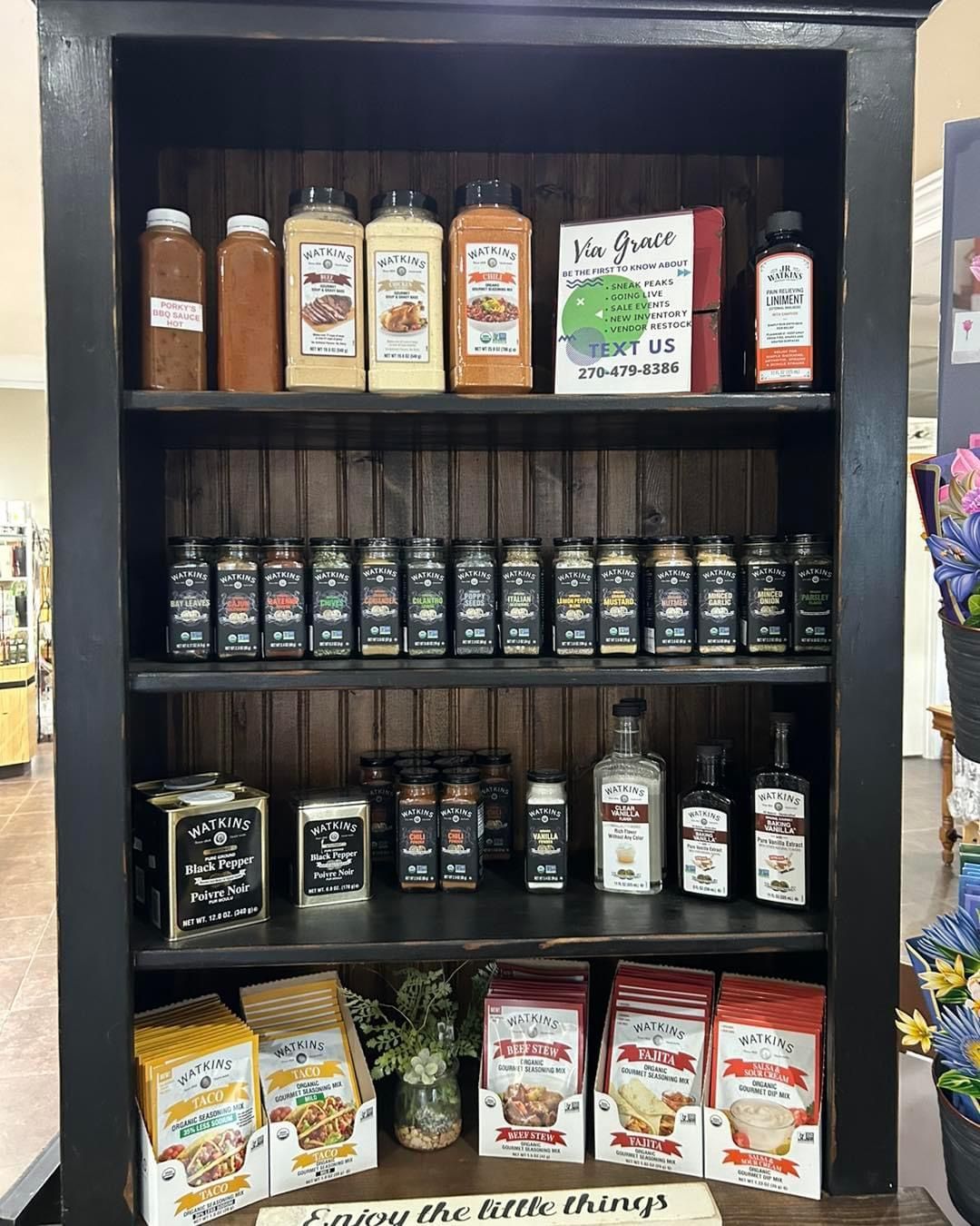 A shelf filled with lots of bottles and boxes of food.