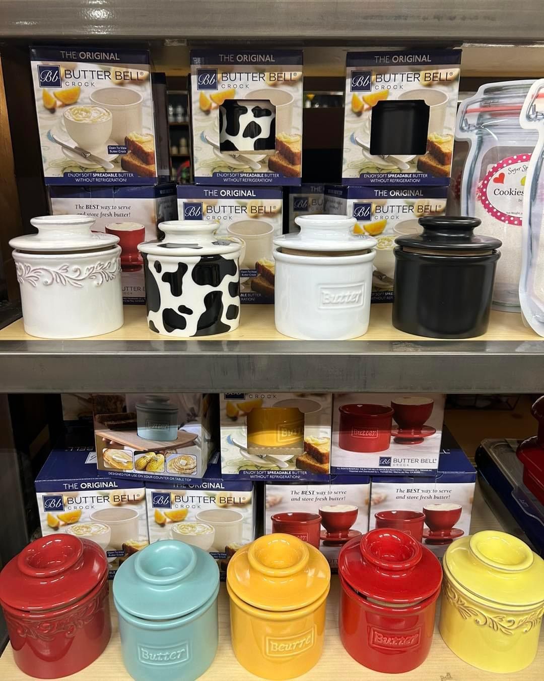 A shelf filled with lots of different colored jars.