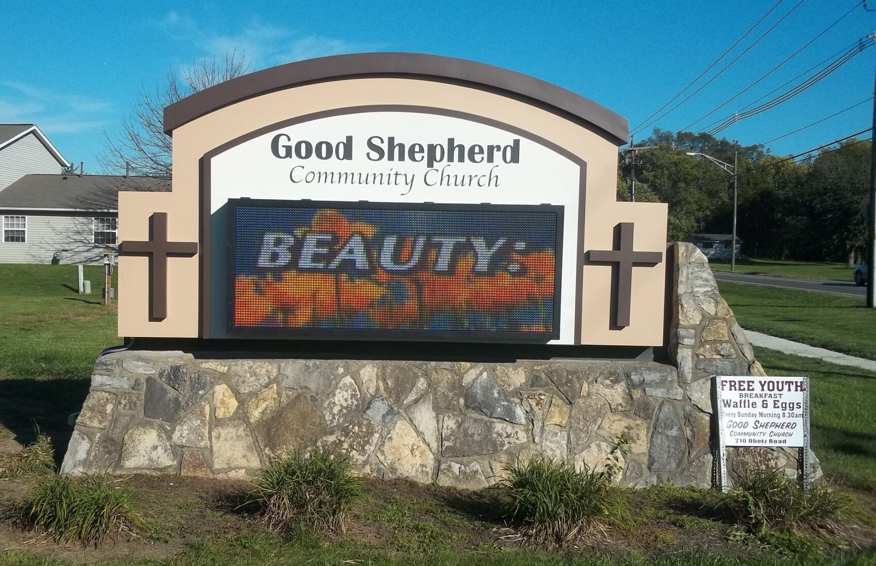 Good Shepherd Community Church sign with LED message board in front of a stone base.