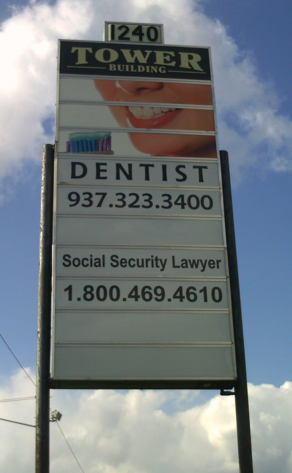Tower Building sign listing dentist and Social Security lawyer offices.
