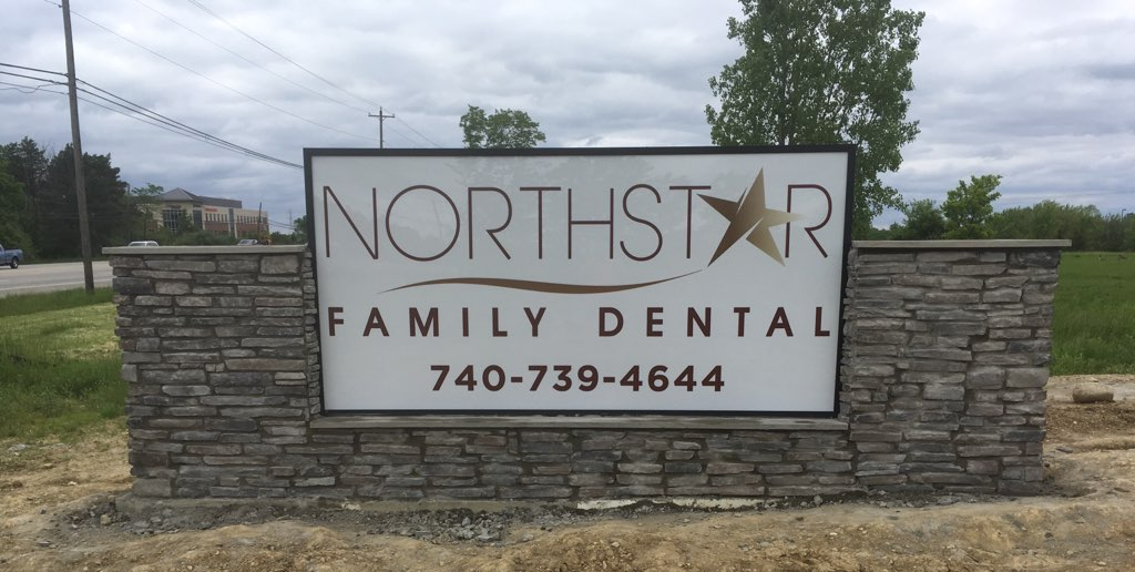 Northstar Family Dental sign on a stone wall with phone number 740-739-4644