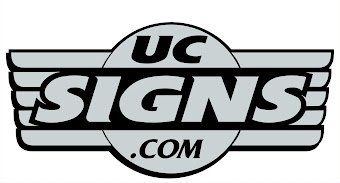 UC Signs.com logo in black, white, and gray with stylized wings