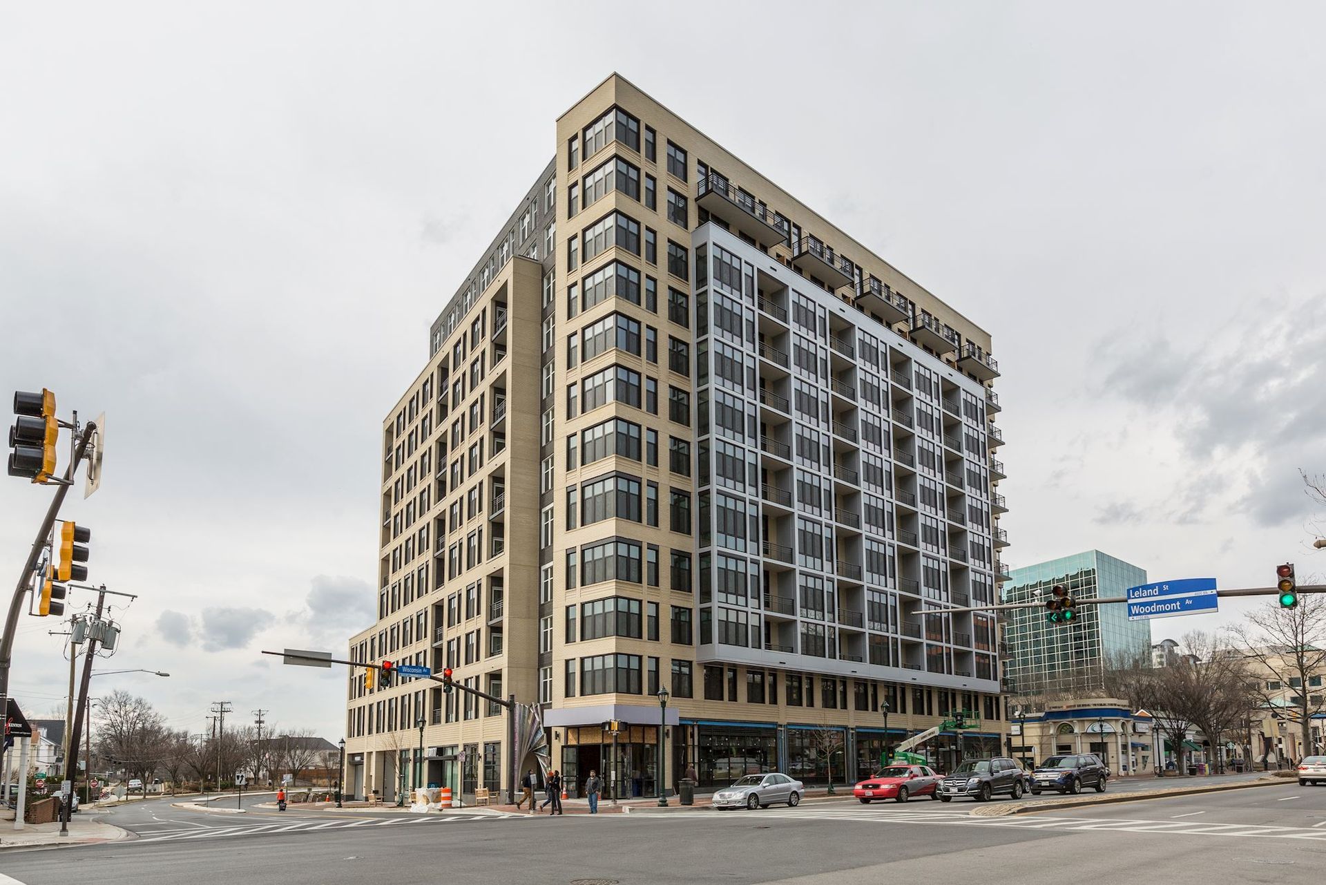 A large building with a parking garage in front of it at Solaire 7077 Woodmont in Bethesda, MD.