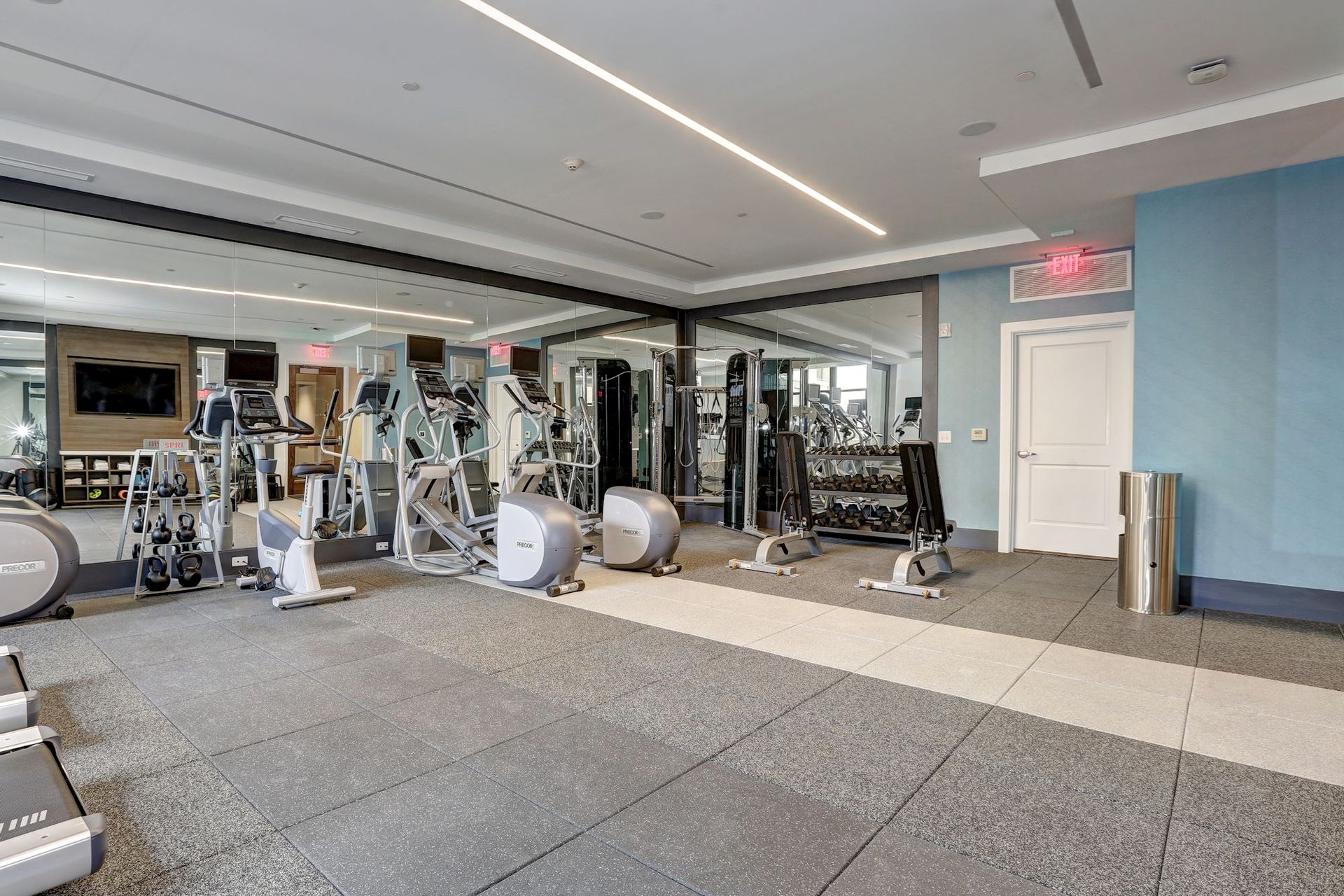 A large gym filled with lots of exercise equipment at Solaire 7077 Woodmont in Bethesda, MD.
