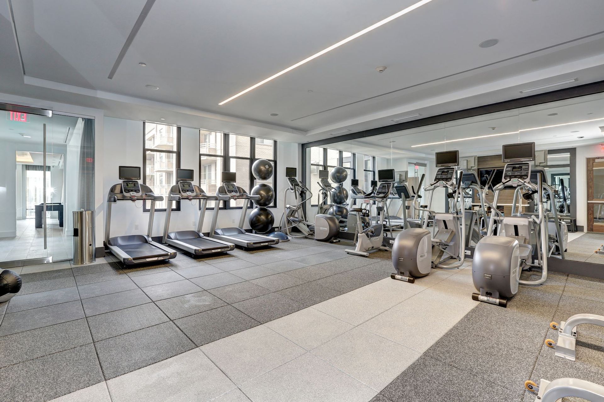 A large gym with a lot of treadmills and exercise equipment at Solaire 7077 Woodmont in Bethesda, MD.
