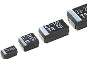 Small black surface-mount electronic components with white printed numbers on a white background