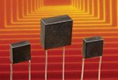 Three dark rectangular speakers on thin stands against an orange geometric background