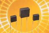 Three dark cubes on white stems against a bright orange sunburst background