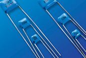 Blue-tinted close-up of several transparent glass syringes or droppers on a blue surface