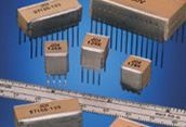 Assorted beige electronic components and integrated circuits arranged on a blue background