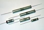 Glass tube fuses with metal end caps and wire leads on a white background