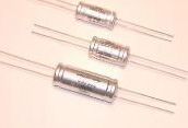 Three silver axial-lead resistors on a light background