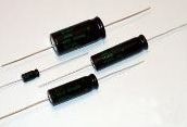 Three black cylindrical diodes with silver leads on a white background
